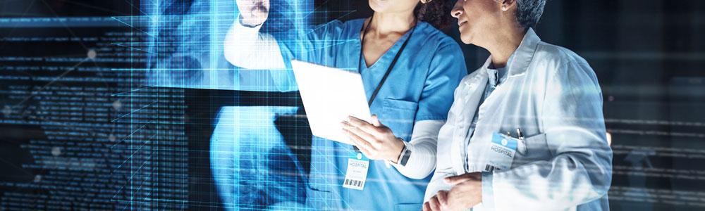 X-Ray being examined by two medical staff.