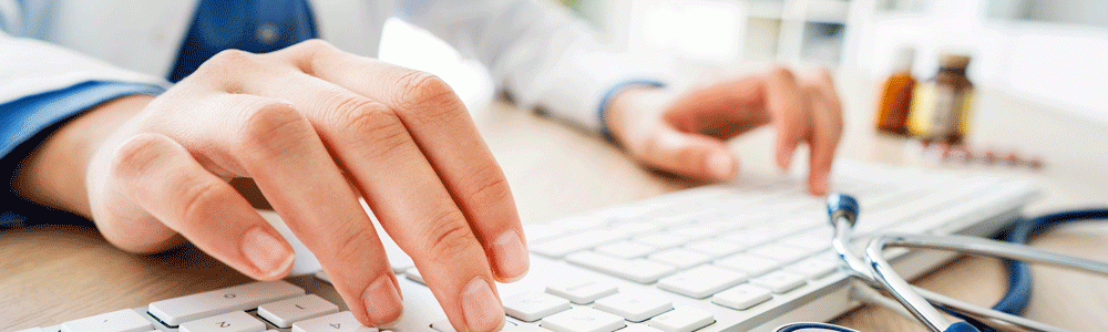 Doctor typing on a keyboard.
