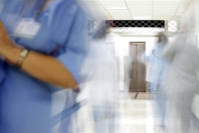 Blurry hospital staff in a corridor