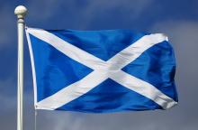 Scottish flag waving in the breeze on a flagpole.