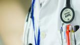 A white doctor's coat with a stethoscope and pens in a pocket.