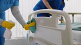 Staff cleaning hospital bed