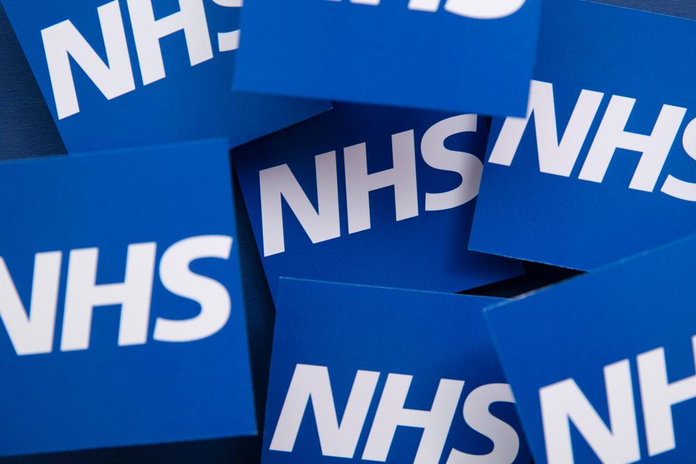 A collection of big blue blocks saying 'NHS.'