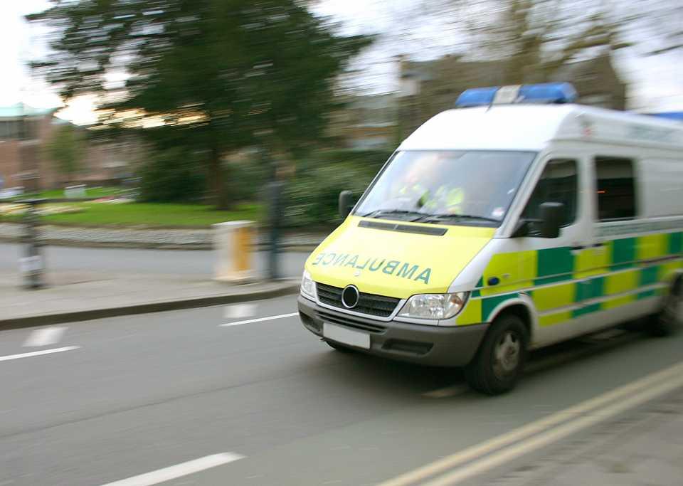 Ambulance speeding along the road.