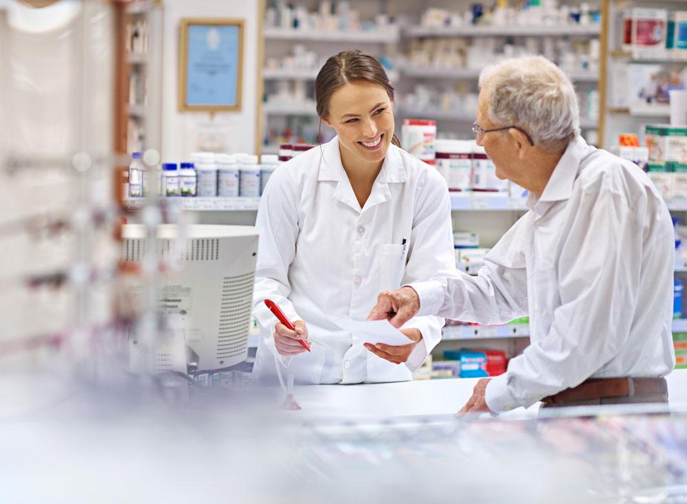Pharmacist giving patient a prescription
