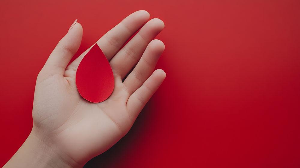 Person holding blood drop