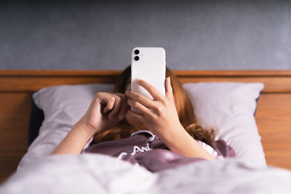 Person in bed on the phone
